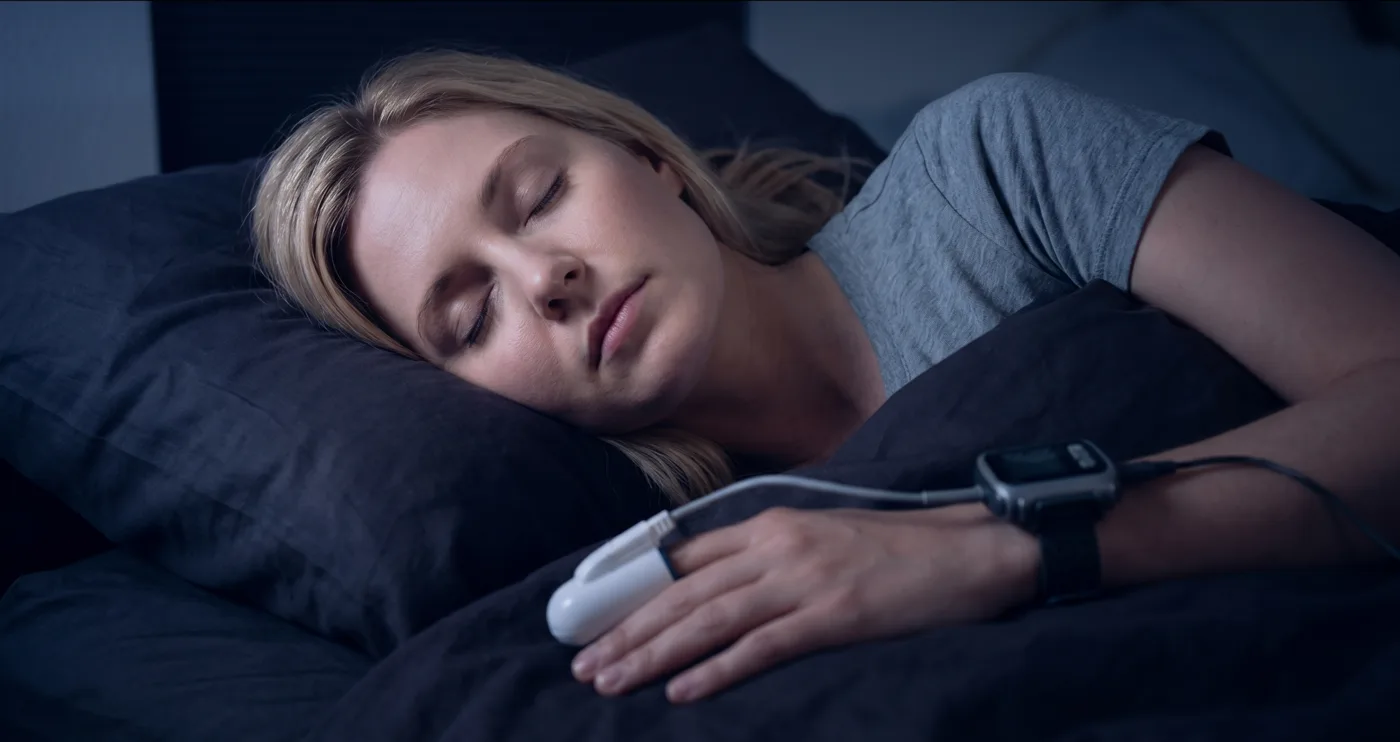Patient using a home sleep study device while sleeping
